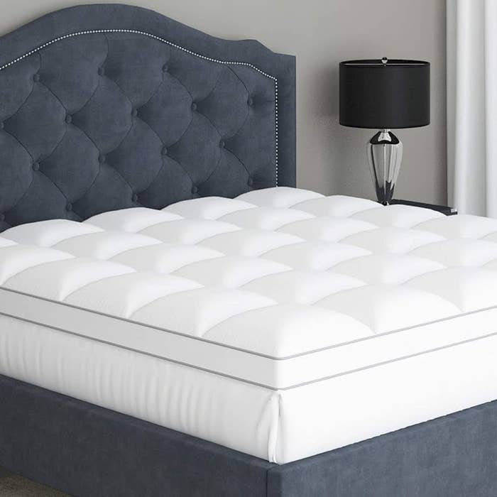 A fluffy mattress topper on a bed