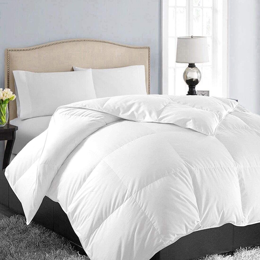 A fluffy duvet on a be with pillows