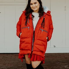 Reviewer wearing the red jacket half zipped