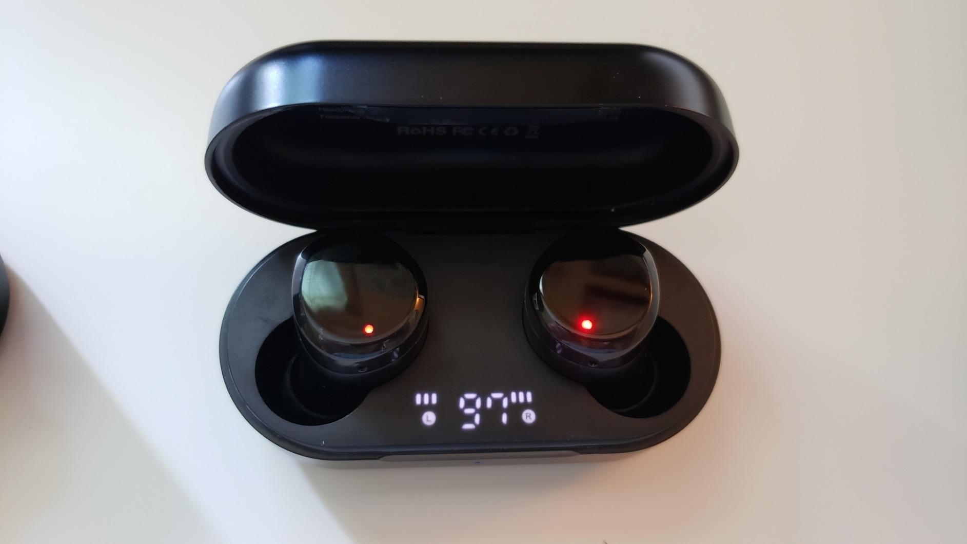 reviewer&#x27;s black wireless earbuds in a charging case