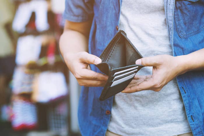 Person holding open an empty wallet
