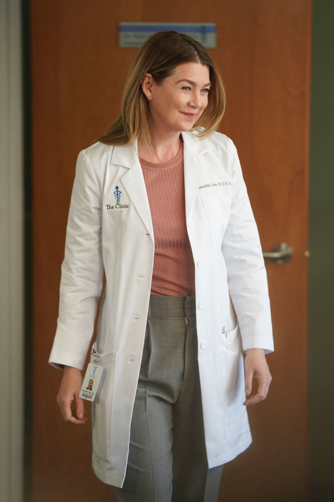 Meredith walking in her white doctor's coat