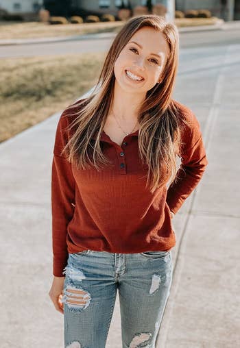 Reviewer wearing the red henley with jeans