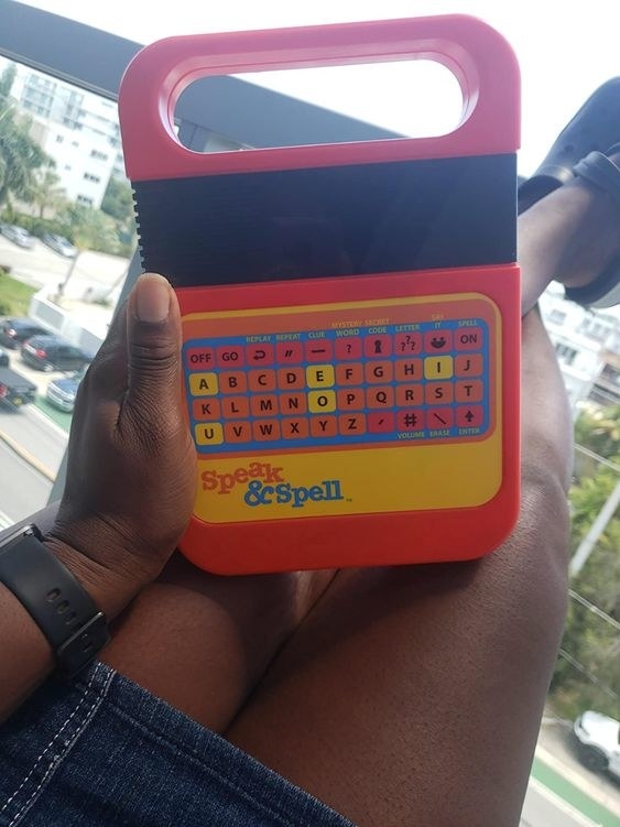 reviewer holding the Red Speak &amp;amp; Spell toy with black screen