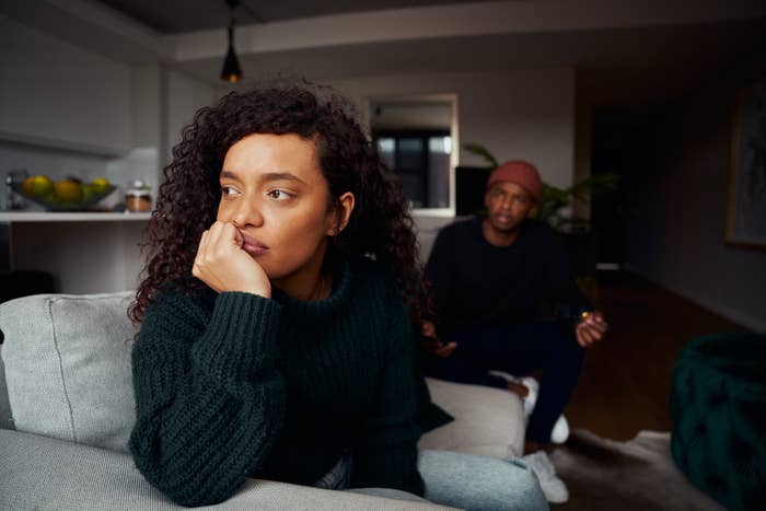 a couple in disagreement, while the woman is looking away, from speaking to her boyfriend