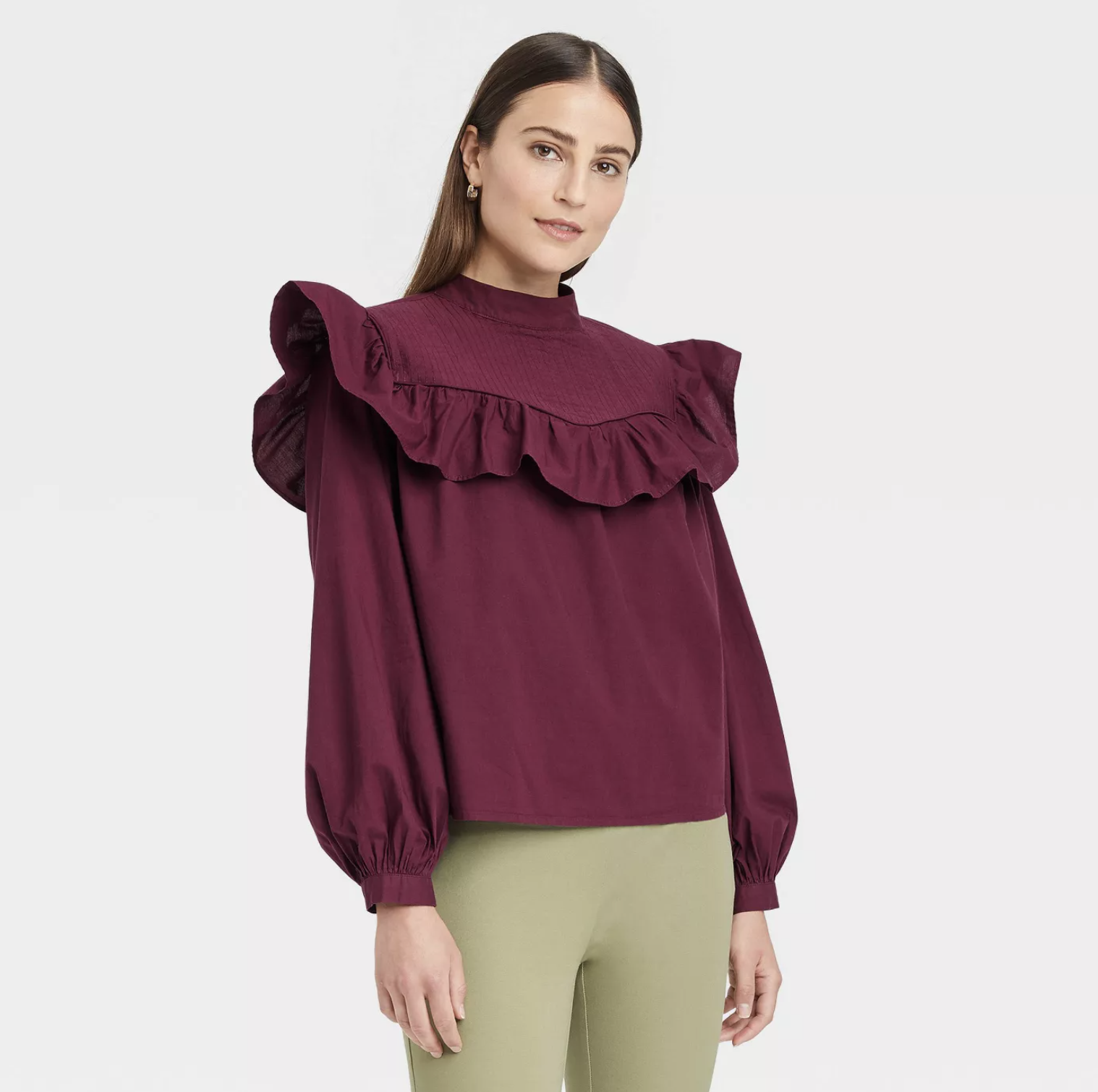 model wearing the shirt in burgundy with ruffled top edge