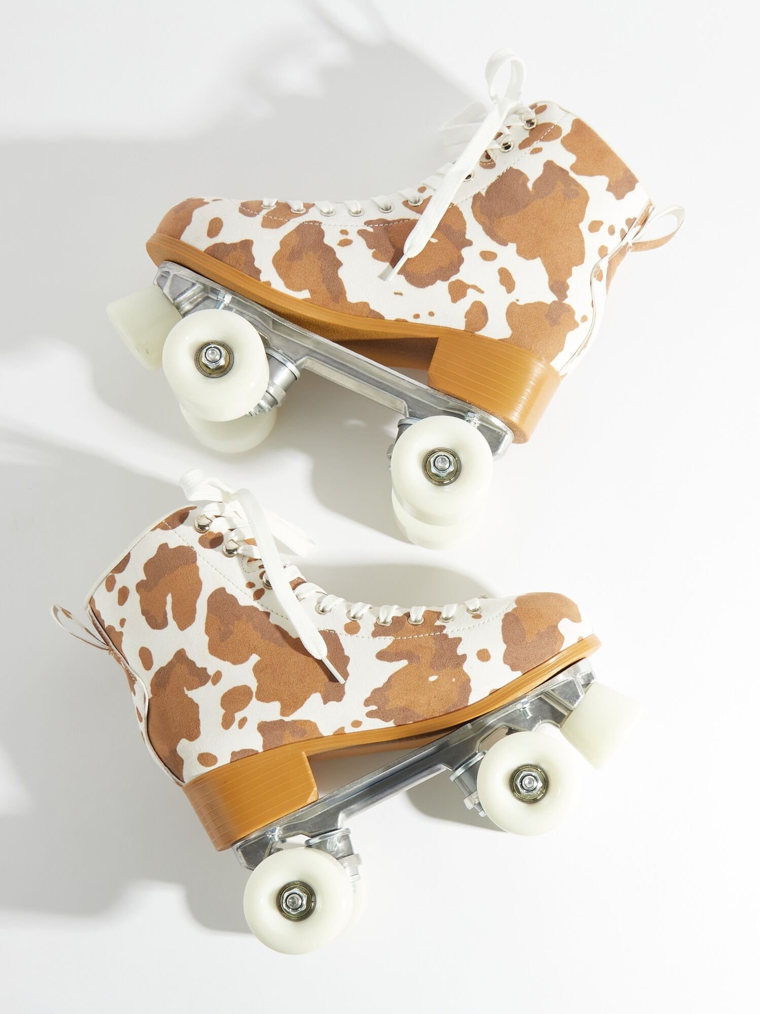 Pair of cow-print roller skates