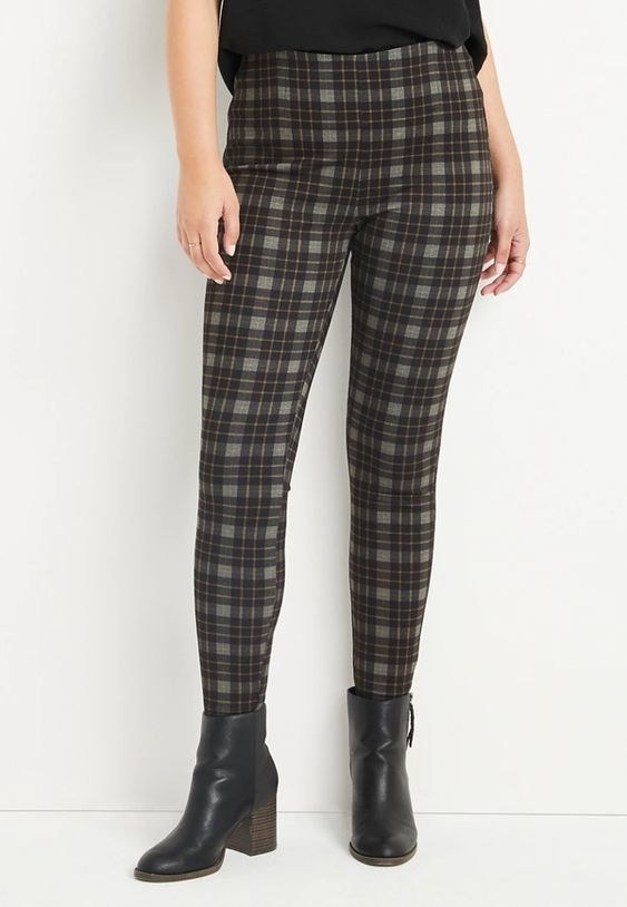 An image of a model wearing a pair of festive plaid high-rise Ponte leggings