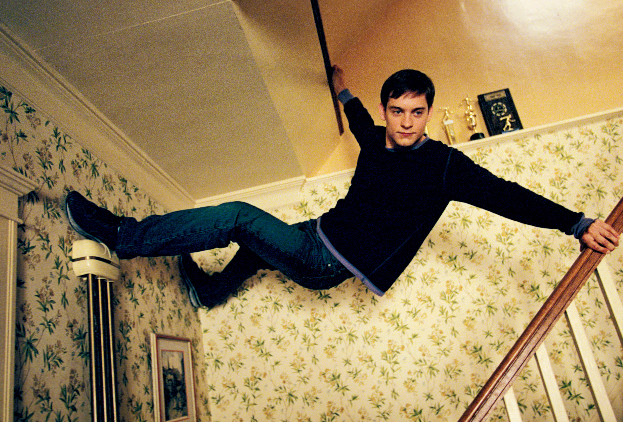 Peter Parker attached to the ceiling of his house
