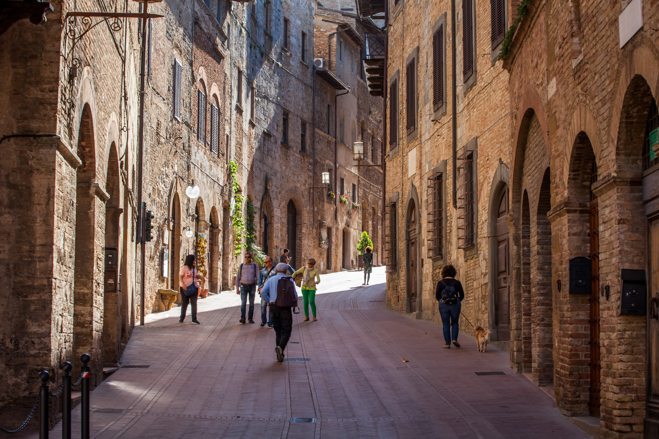 People strolling in a narrow medieval town