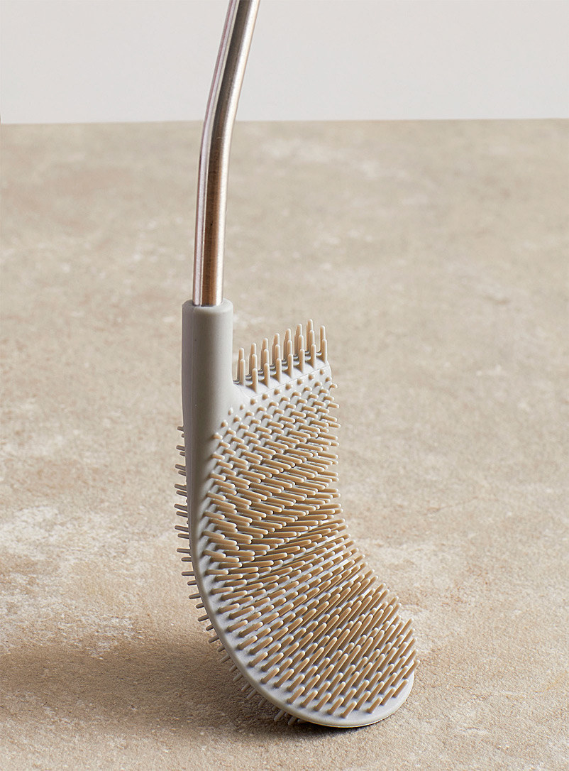 A flatlay of the toilet brush to show off its curved, flexible shape