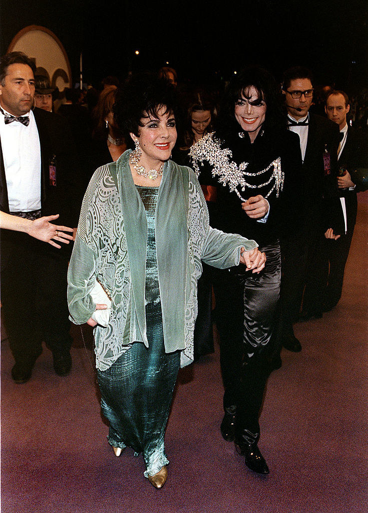 Elizabeth Taylor and Michael walking hand-in-hand at her birthday party