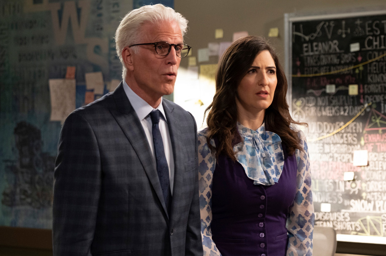 Michael and Janet from The Good Place stand in a classroom and look concerned at someone out of frame