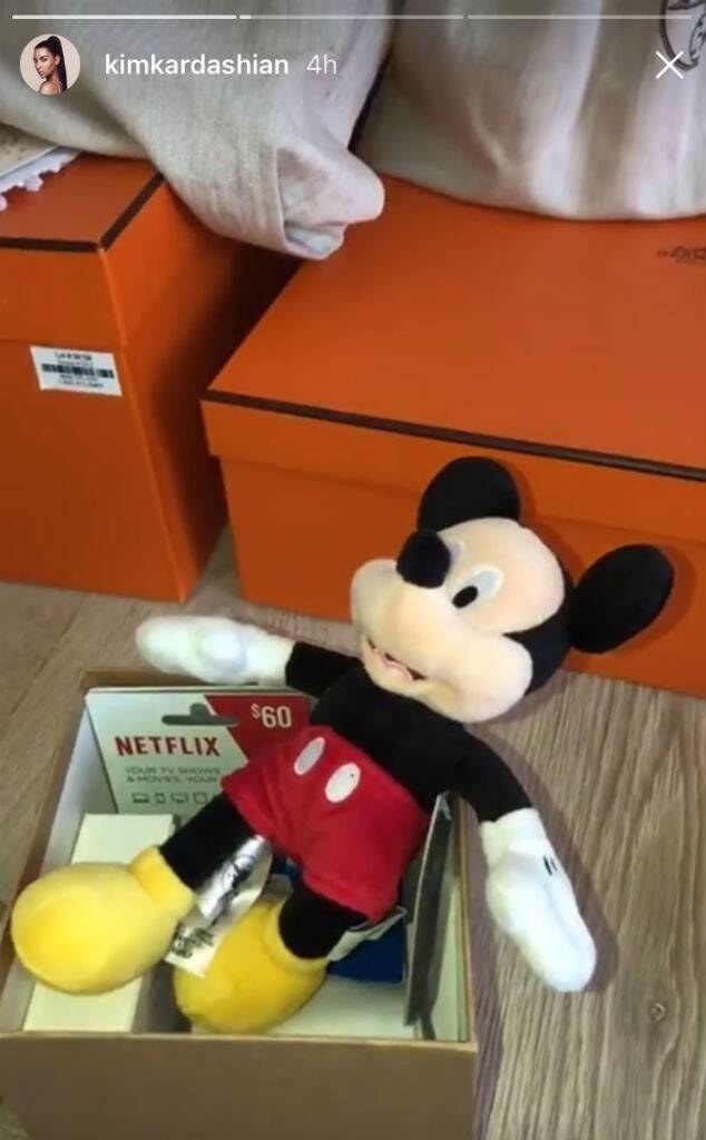A box with some Netflix gist cards and a plush Mickey Mouse doll