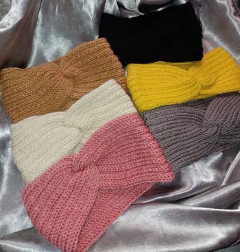 Reviewer photo of six headbands in tan, white, pink, black, yellow, and gray