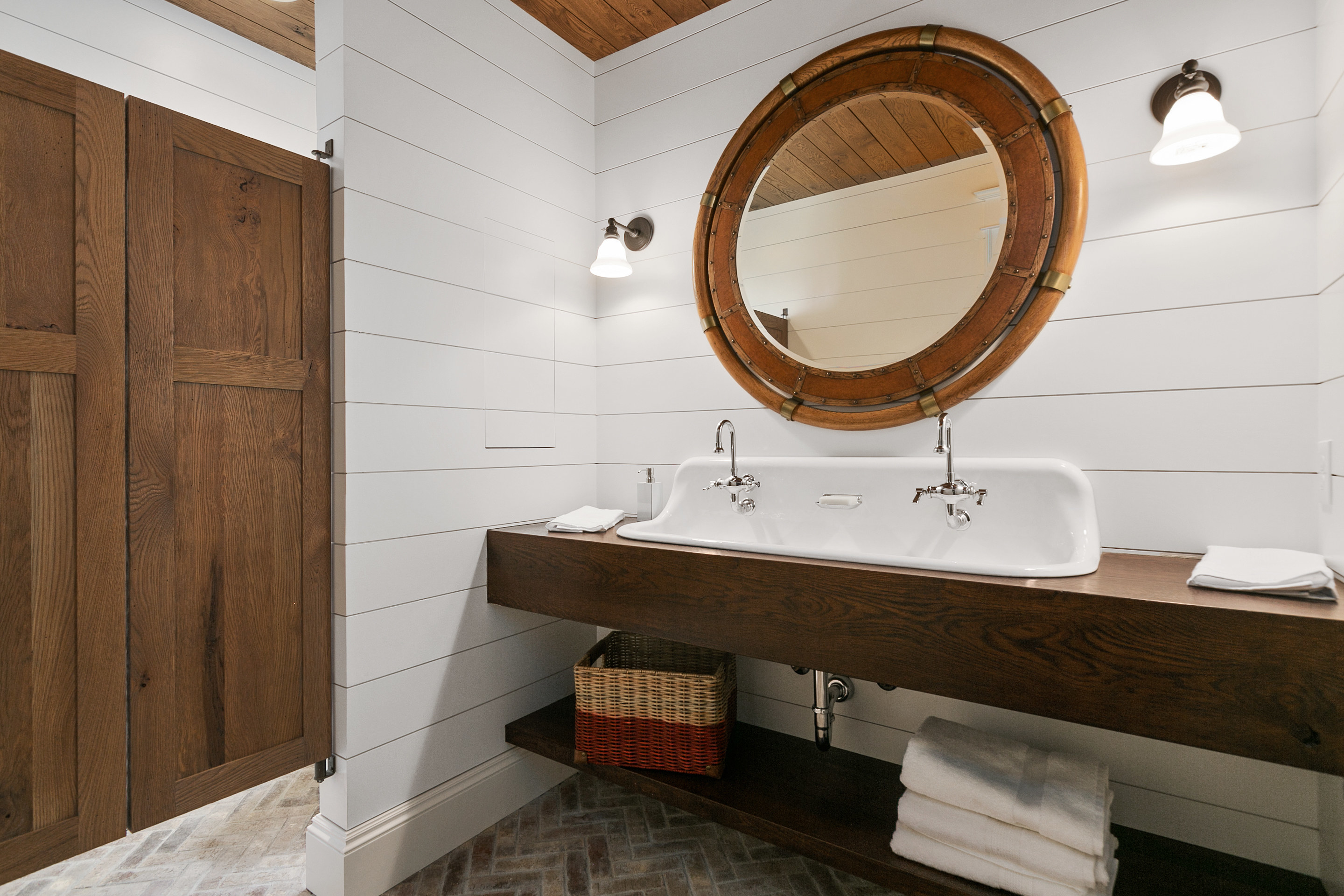 White shiplap wall in a bathroom with natural wood accents