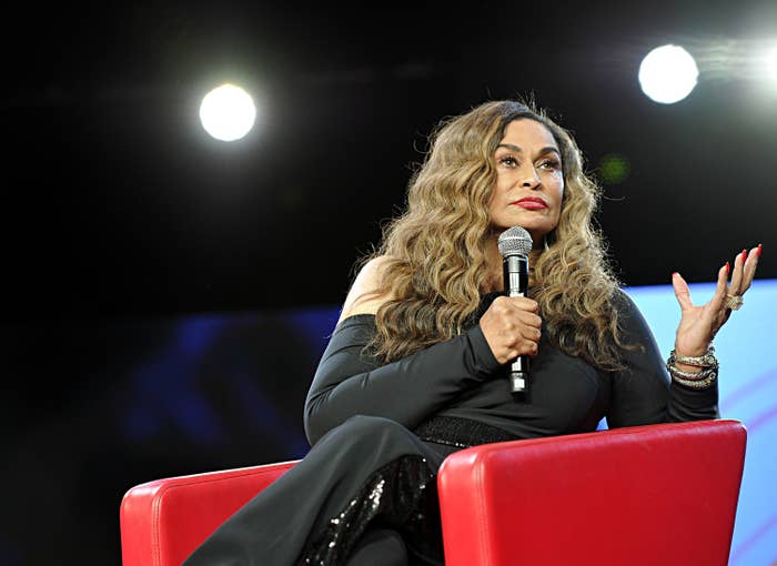 Tina Knowles-Lawson sits in a chair while holding a microphone