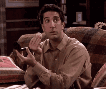 GIF of Ross from Friends with way too white teeth
