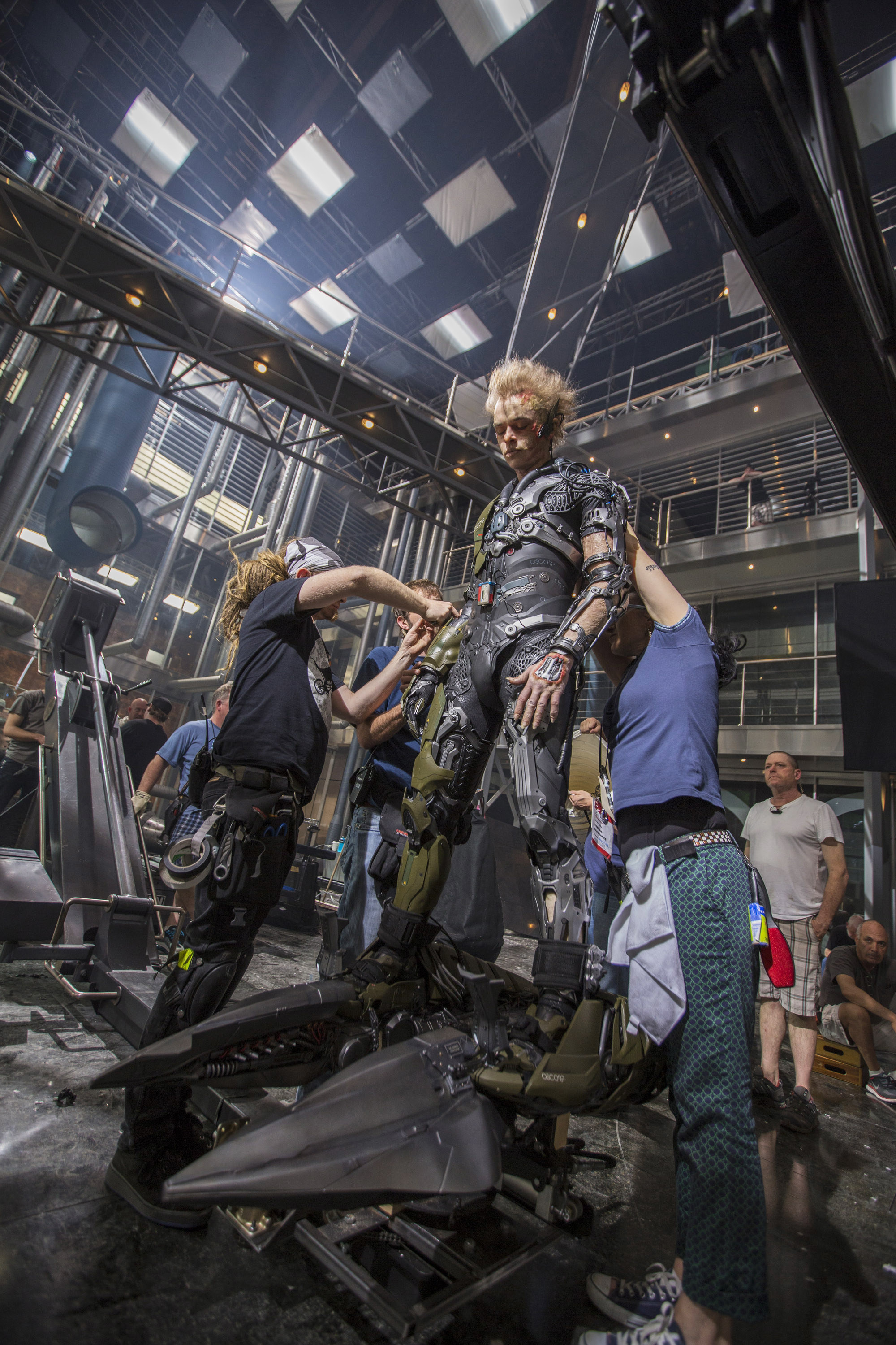 DeHaan being put into his costume on set