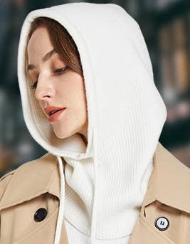 Model wearing the white pullover hood with a trench coat