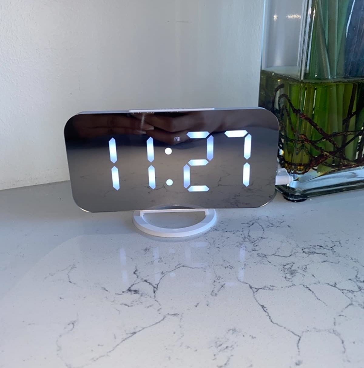 mirrored alarm clock on a marbled surface