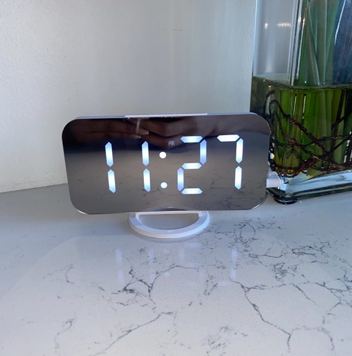 mirrored alarm clock on a marbled surface