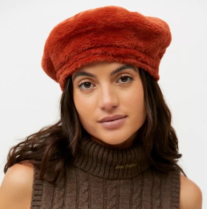 Model wearing the red furry beret