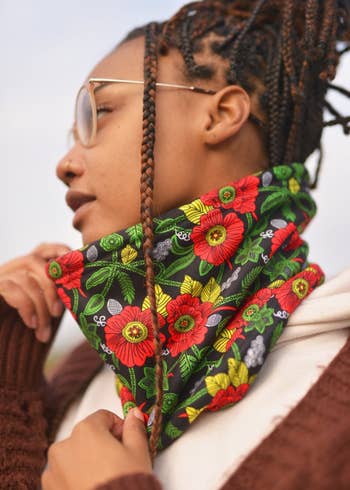 Side view of model wearing the floral neck gaiter