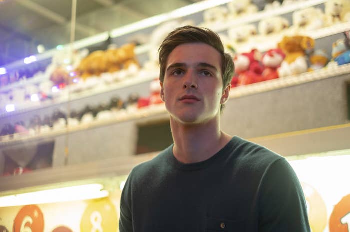 Jacob's character standing in front of a carnival game