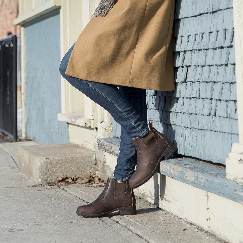A person wearing wool-lined chelsea boots