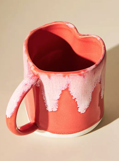 a red mug shaped like a heart
