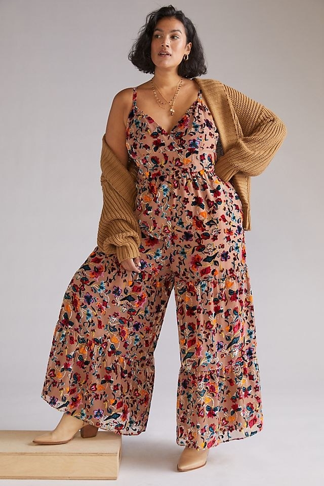 Model posing in floral jumpsuit