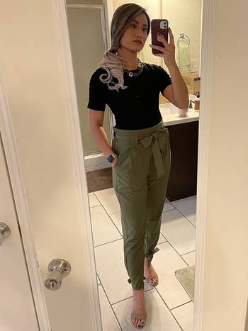 reviewer wearing olive green version