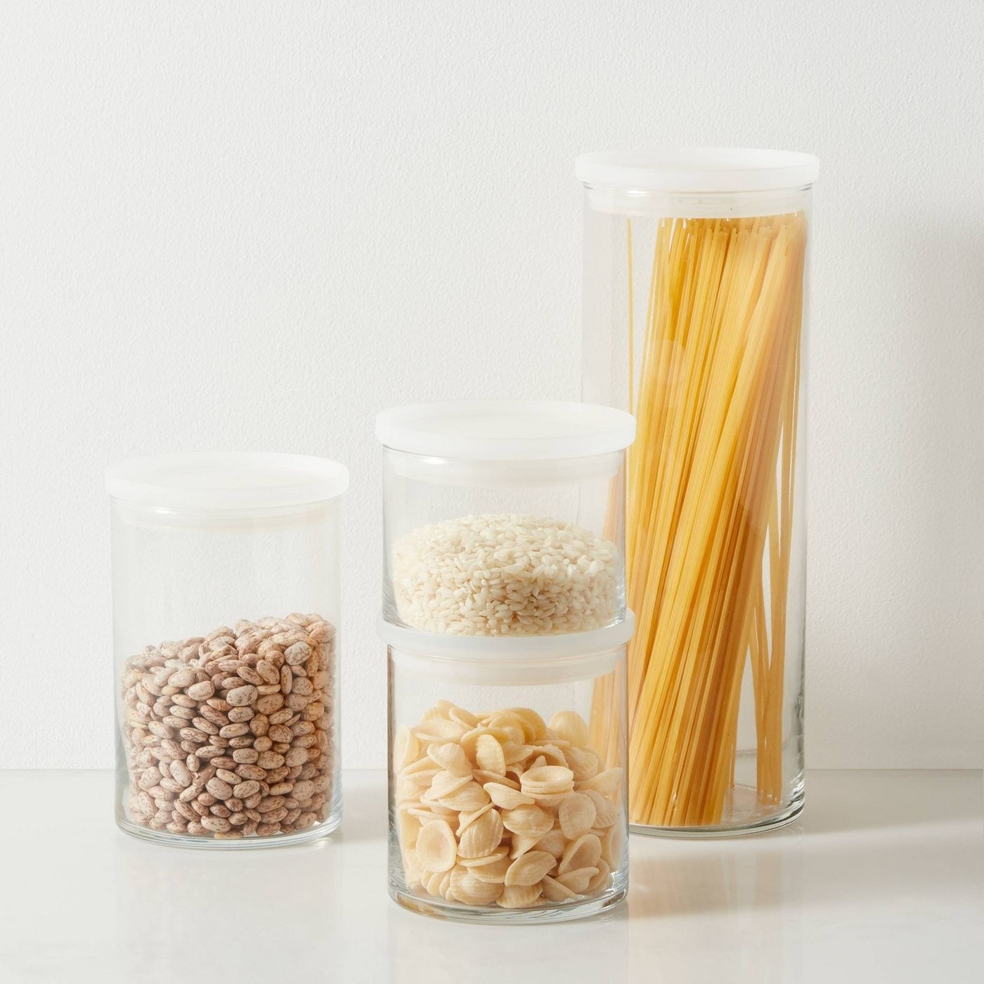 the small jar full of rice with other sizes of jars of dry goods