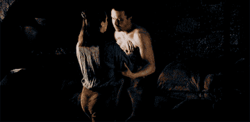 Arya pushes Genry down as she starts to undress