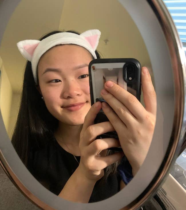 a reviewer in the white cat headband