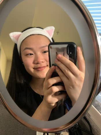 a reviewer in the white cat headband