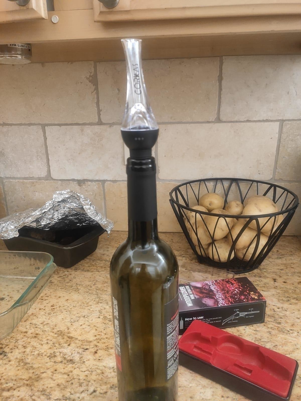 reviewer image of the aerator inside a wine bottle