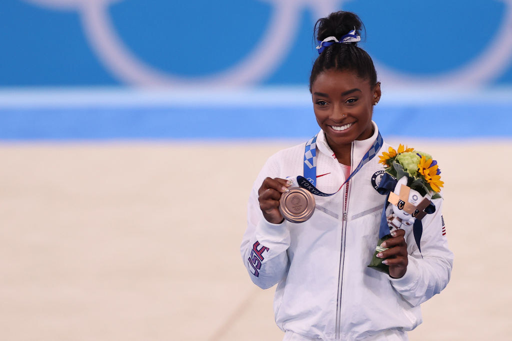 Simone holding up her medal