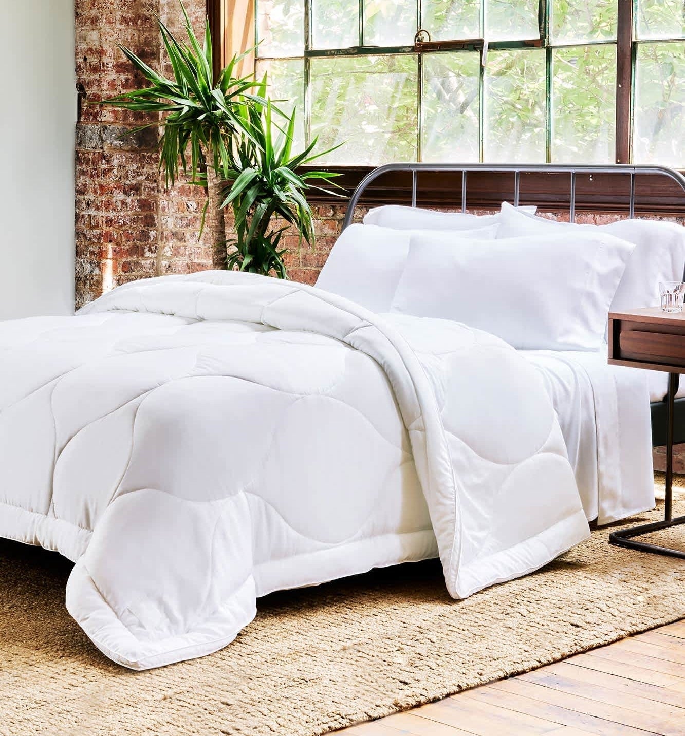 the down alternative comforter on a metal bed