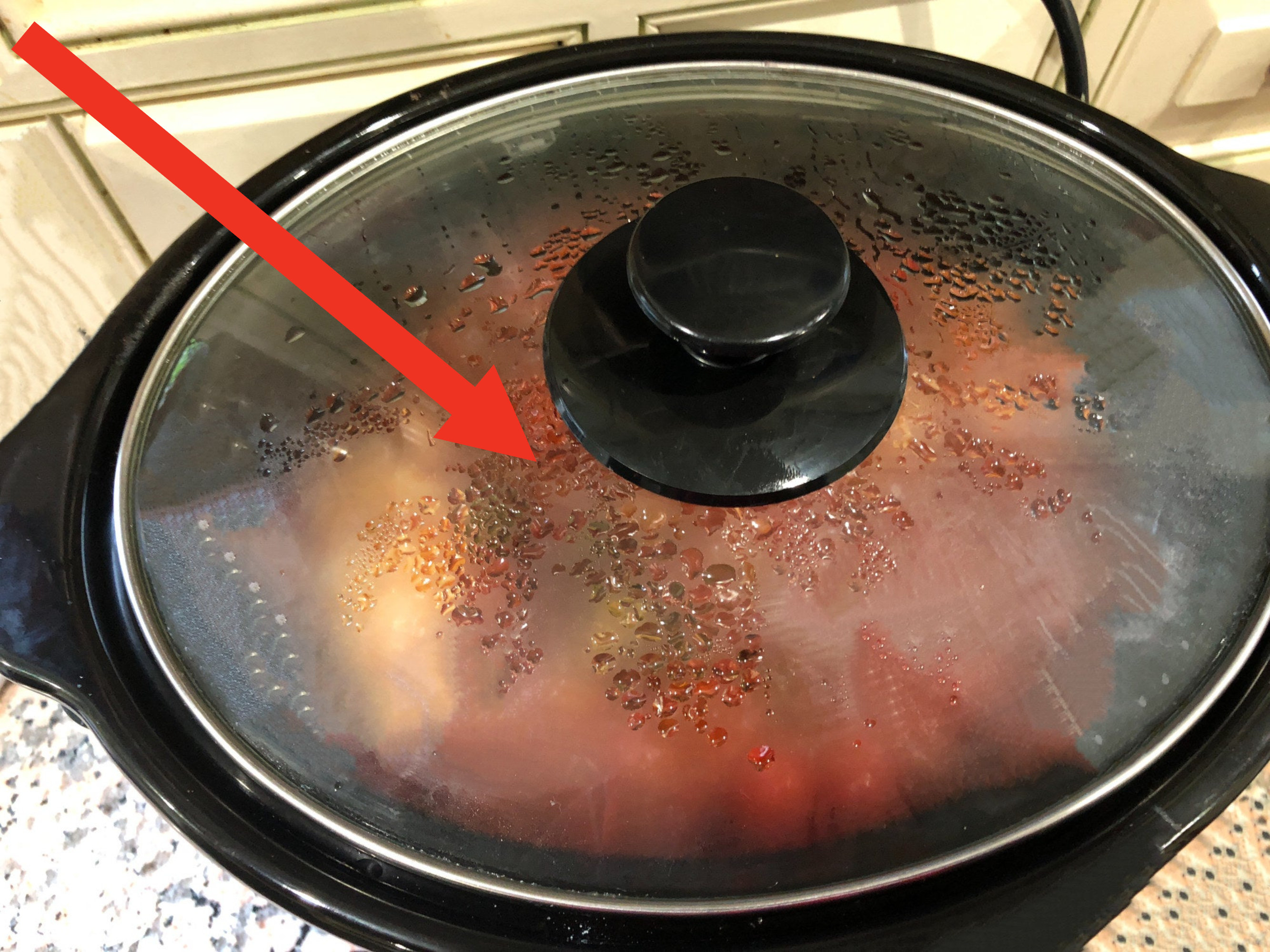 A slow cooker with condensation.
