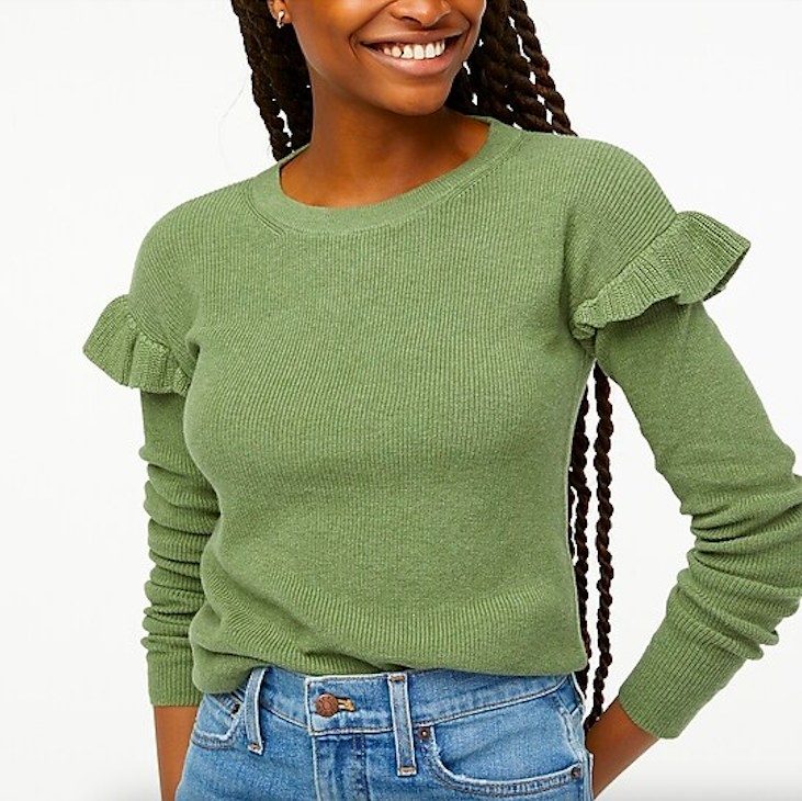 Model wearing green pullover sweater and jeans