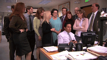 A group of people on The Office looking at the camera in disbelief