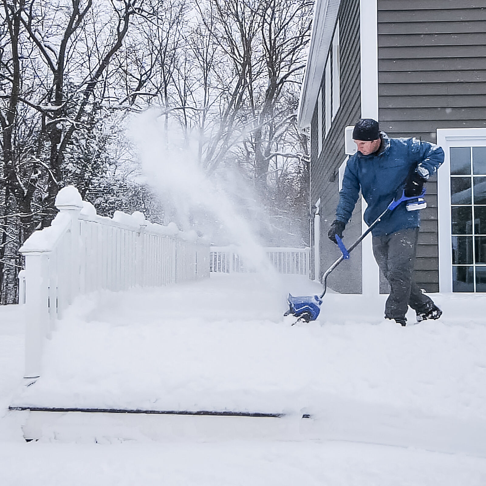 Person shoveling snow with the cordless shovel