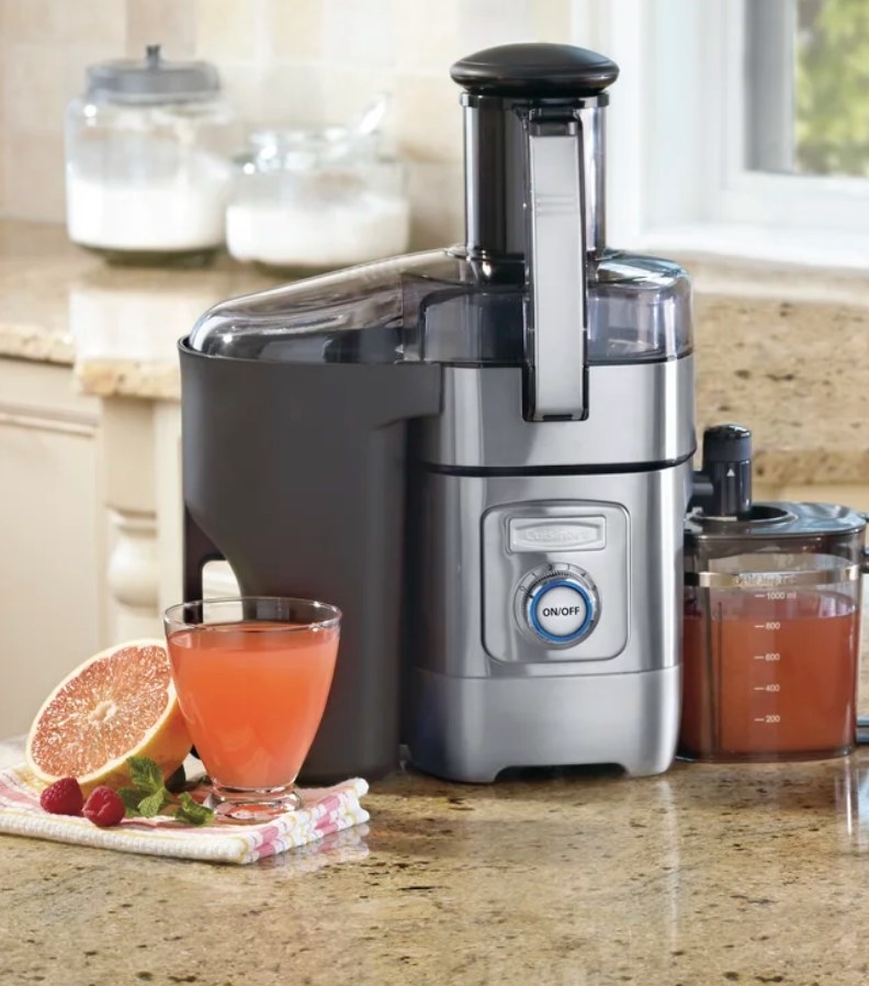 A juice maker atop a kitchen counter