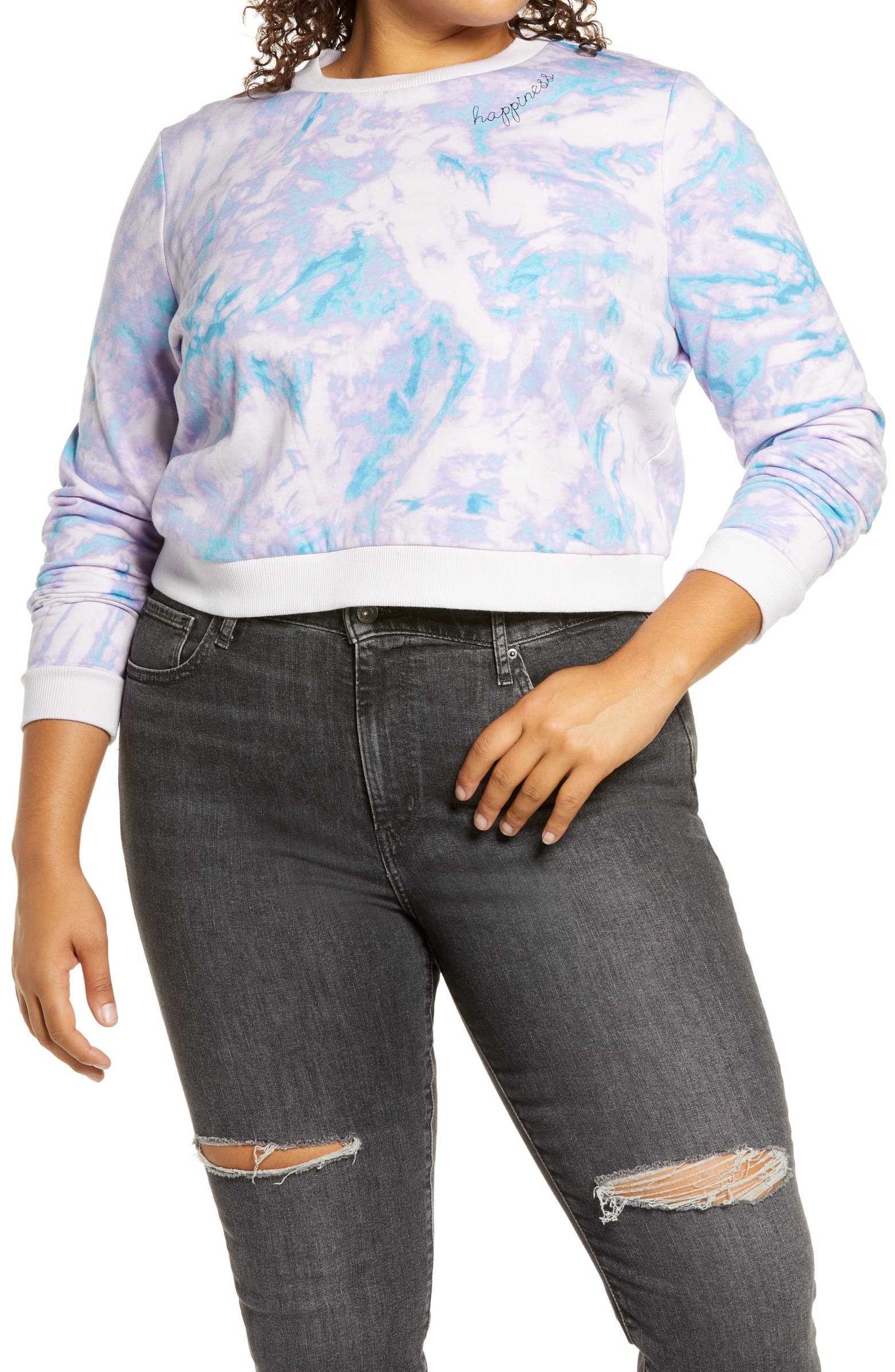 model wearing crop tie-dye sweatshirt with jeans