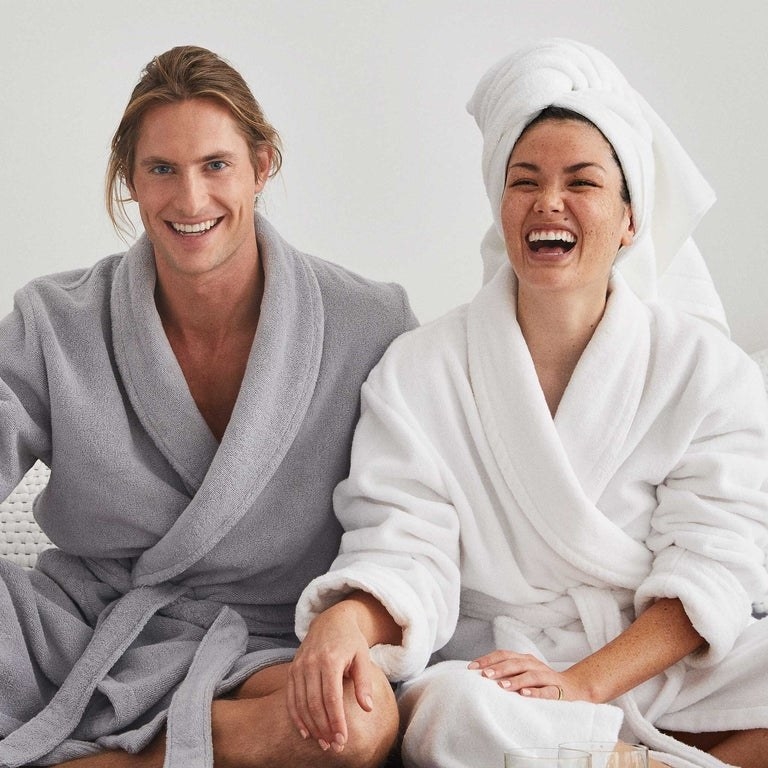 Models wearing gray and white plush robes