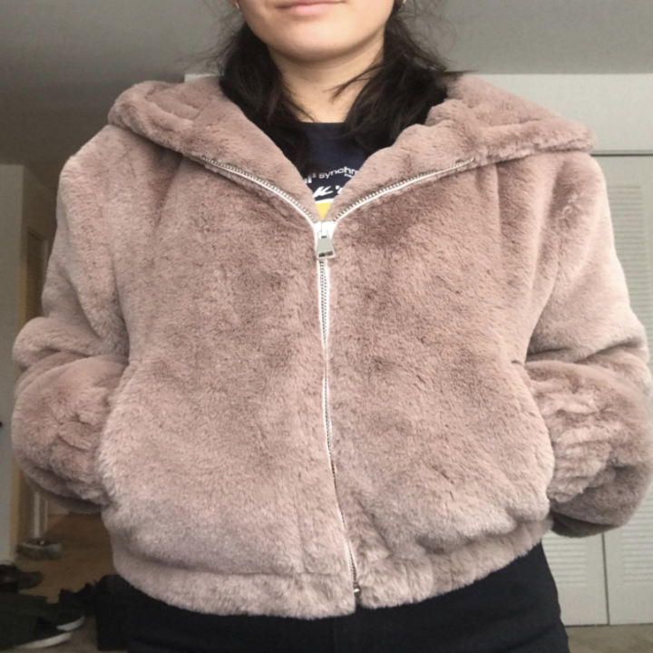 reviewer wearing zip up jacket