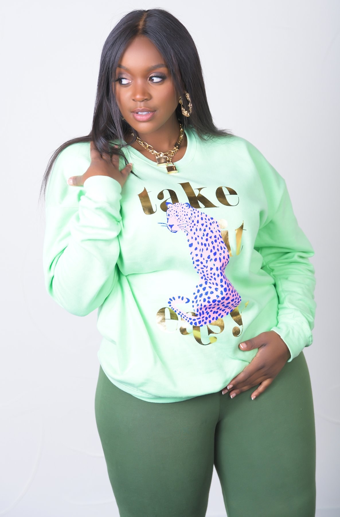 model wearing sweatshirt with a cheetah cartoon on it and a &quot;take it easy&quot; message