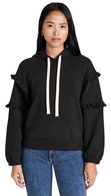 model wearing a sweatshirt with ruffles on the sleeves